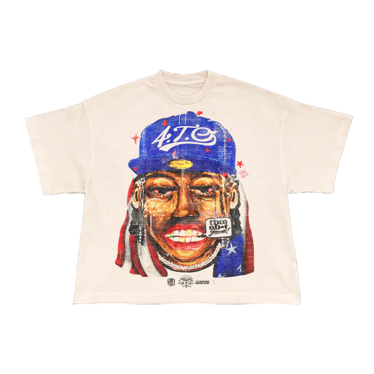 T-shirt with a graphic of a person wearing a blue cap and red headband on a beige background